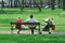Couple with a baby carriage resting in the park