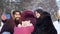 Couple with baby take selfie on walk. Young married couple with baby in pram take selfie on walk in winter. Modern young