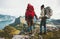 Couple backpackers holding hands enjoying mountains