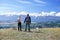 Couple backpackers holding hands enjoying mountains.