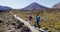 Couple Backpackers Walking On Footpath To Tongariro National Park