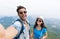 Couple With Backpacks Take Selfie Photo Over Mountain Landscape Trekking, Young Man And Woman On Hike Tourists