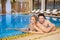 Couple in bathing suits in the pool resting spa center