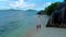 Couple on the beach of Anse Source D\'Argent the most beautiful beach of Seychelles. La Digue Island