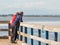 Couple at the beach.Elderly couple looking to the sea. Senior family couple relaxing by autumn lake
