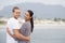 Couple, beach and happy with hug on holiday for honeymoon, love and relax in New Zealand. Portrait, relationship and