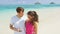 Couple on beach vacation using smart phone app