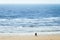 Couple at the beach watching the waves and the panoramic view of the sea