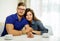 Couple behind table at home