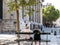 Couple on bench watches summer scene in Place Saint-Sulpice, Paris