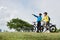 Couple on Bicycles Standing on Hill