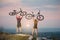 Couple bicyclist with mountain bikes on the hill at sunset