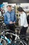 couple in bike shop buying bicycle after buying