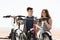 Couple with bikes on beach