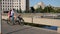 Couple with bikes look at river from bridge with railing