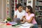 Couple of black students working with science project in library