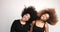Couple of black womans with huge afro hair dancing and shaking heads