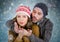 Couple blowing kisses against blue bokeh background