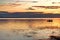 A couple in the boat during the sunset on the lake