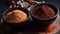 a couple of bowls filled with different types of spices on top of a table