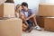 Couple, boxes and happy with hug for real estate, new home or property investment with romance or love. Moving, man and