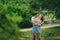 Couple in bright clothes walks in a summer park in the city. Walk in the fresh air. Date of two lovers. The period of co