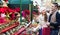 Couple buying Christmas flower at market