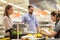 Couple buying food at grocery store cash register
