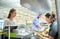 Couple buying food at grocery store cash register