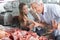 Couple Buying Meat At Butcher\'s Shop