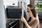 Couple Buying Microwave Oven With Consumer Loan