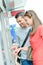 Couple buying travel ticket from machine