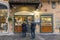 A couple buys food in a store in the center of the city