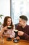 Couple In Cafe Drinking Coffee