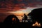 Couple camping with guitar and campfire on the beach