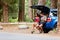 Couple on car road trip travel in eating in forest