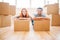 Couple with cardboard boxes in hands, new home