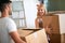 Couple with cardboard boxes in new home