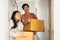 Couple carry boxes to bedroom of new house