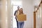 Couple Carrying Boxes Into New Home On Moving Day