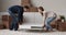 Couple carrying table to living room hugging celebrate relocation day