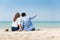 Couple in casual sitting on the sand at the beach