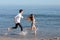 Couple chasing and running on the beach