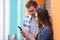 Couple checking smart phone messages in the street