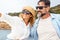 Couple of cheerful mature couple of tourists man and woman sitting inside a boat enjoying excursion tour admiring coast and ocean