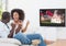 Couple cheering while watching rugby match on television