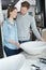 Couple chooses bathroom furniture in home improvement store