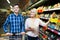 Couple choosing cheese at shop