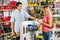 Couple Choosing Tools In Hardware Store