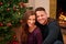 Couple, christmas and portrait together in home with smile, happiness and bonding with christmas tree. Man, woman and